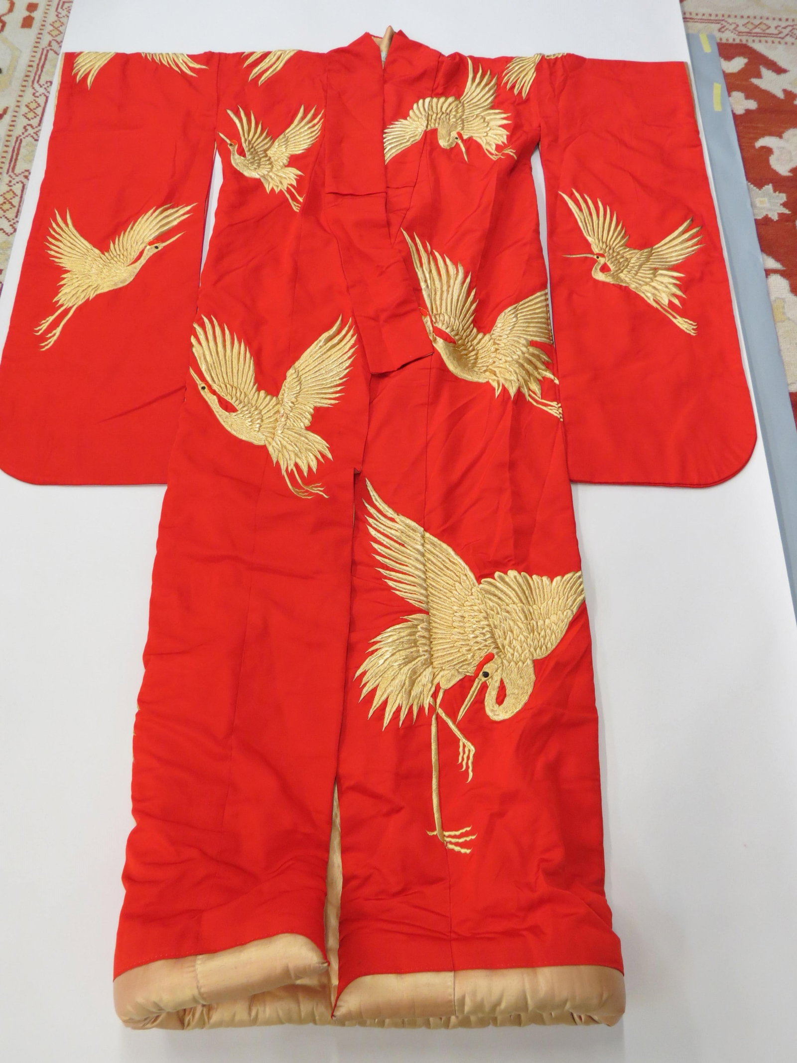 Japanese Embroidered Silk Komono with Gold Thread,: flying cranes on red, apprx. 72" long, 52" wide.