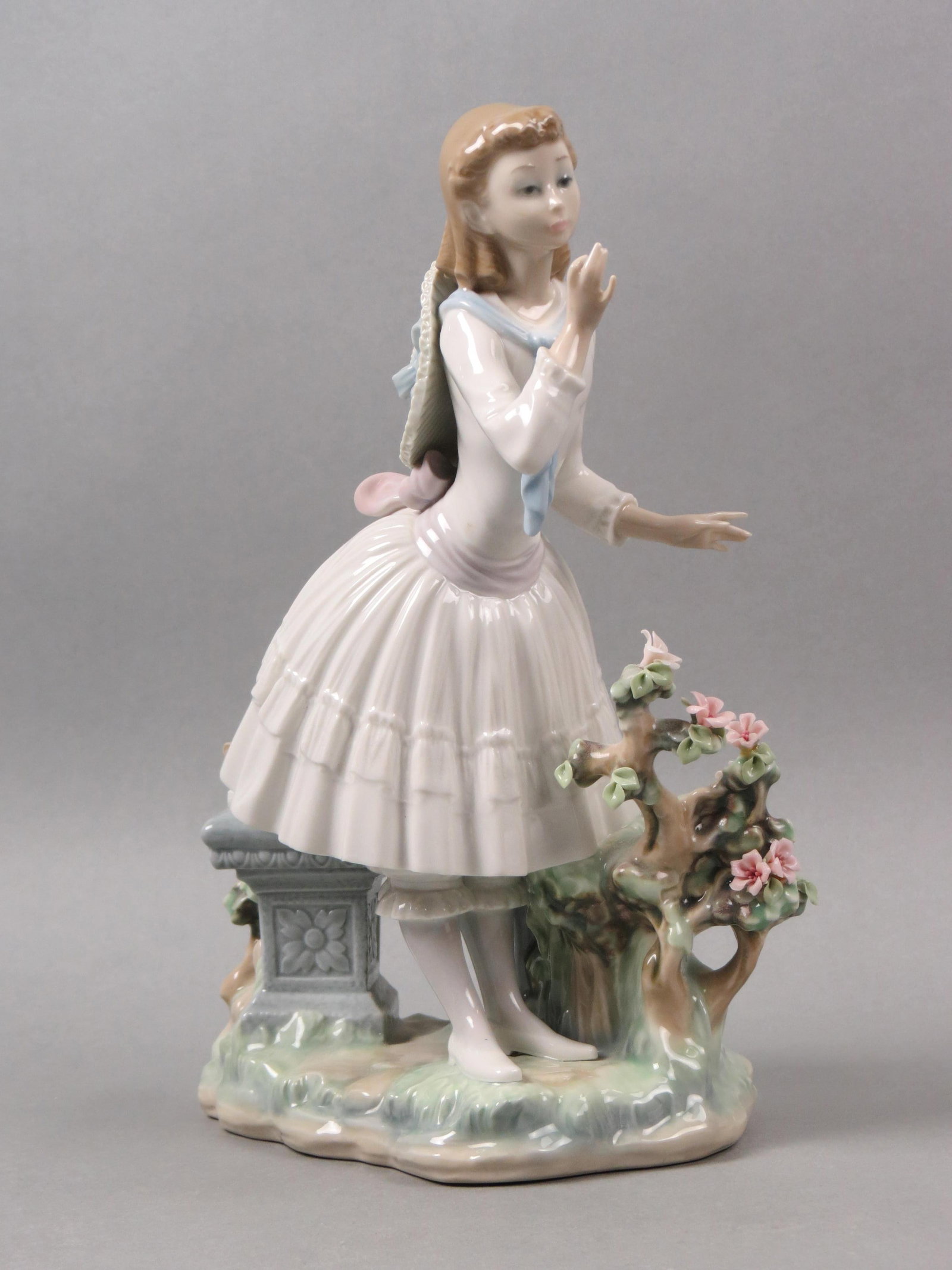 Lladro Porcelain Figurine of Girl with Flowers,: bench by her side, 11 1/4", excellent, with box........ Due to fragile nature of the Lladro figurines (fingers and flowers mostly) if you want them shipped by in-house shipping we will no longer be in