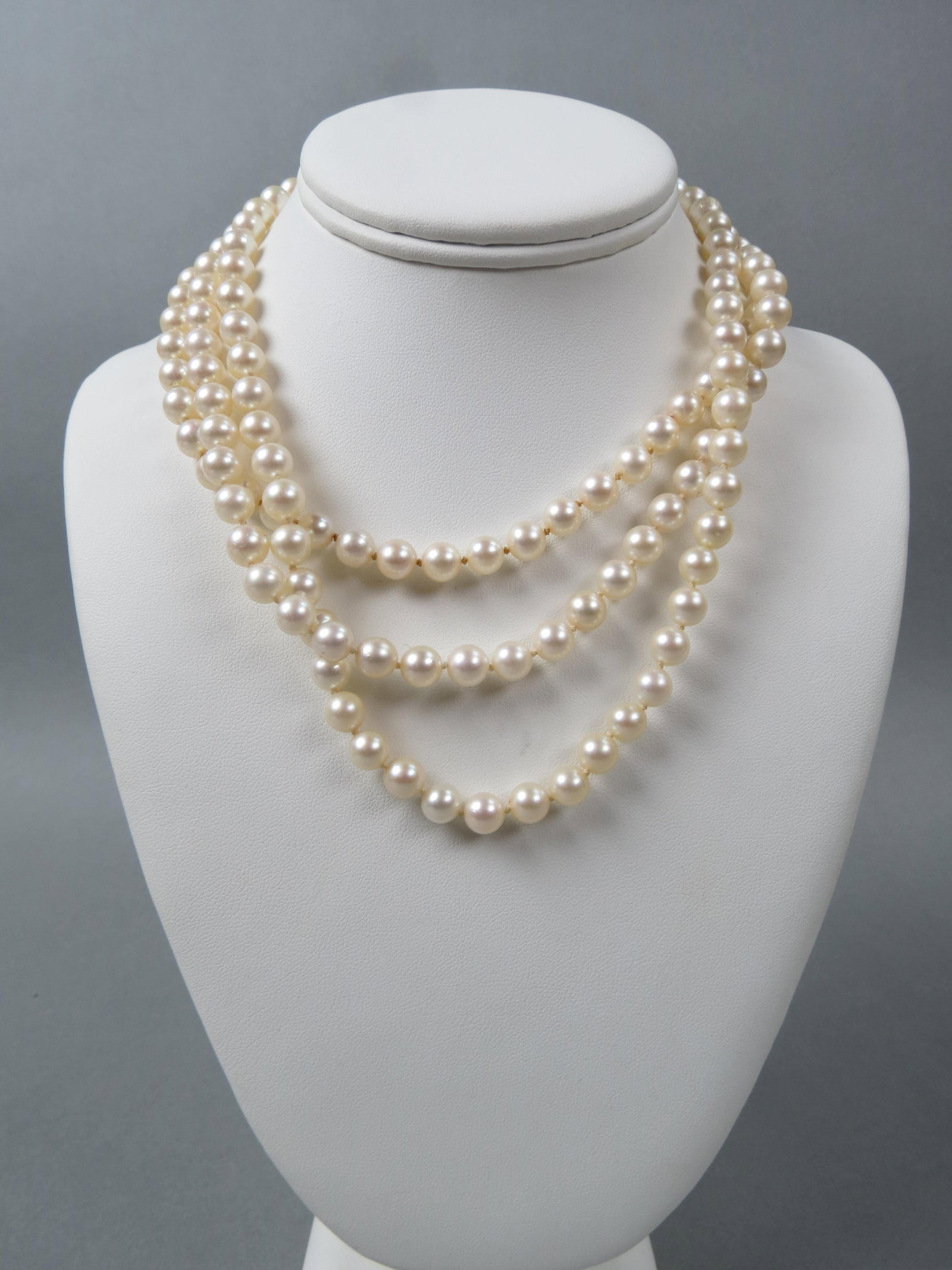 Pearl & 14K Gold Necklace, 148 lustrous pearls: in cream rose color, 7 to 7.5 mm, with 14K white gold clasp, with appraisal of $1,850.00, 16" long.