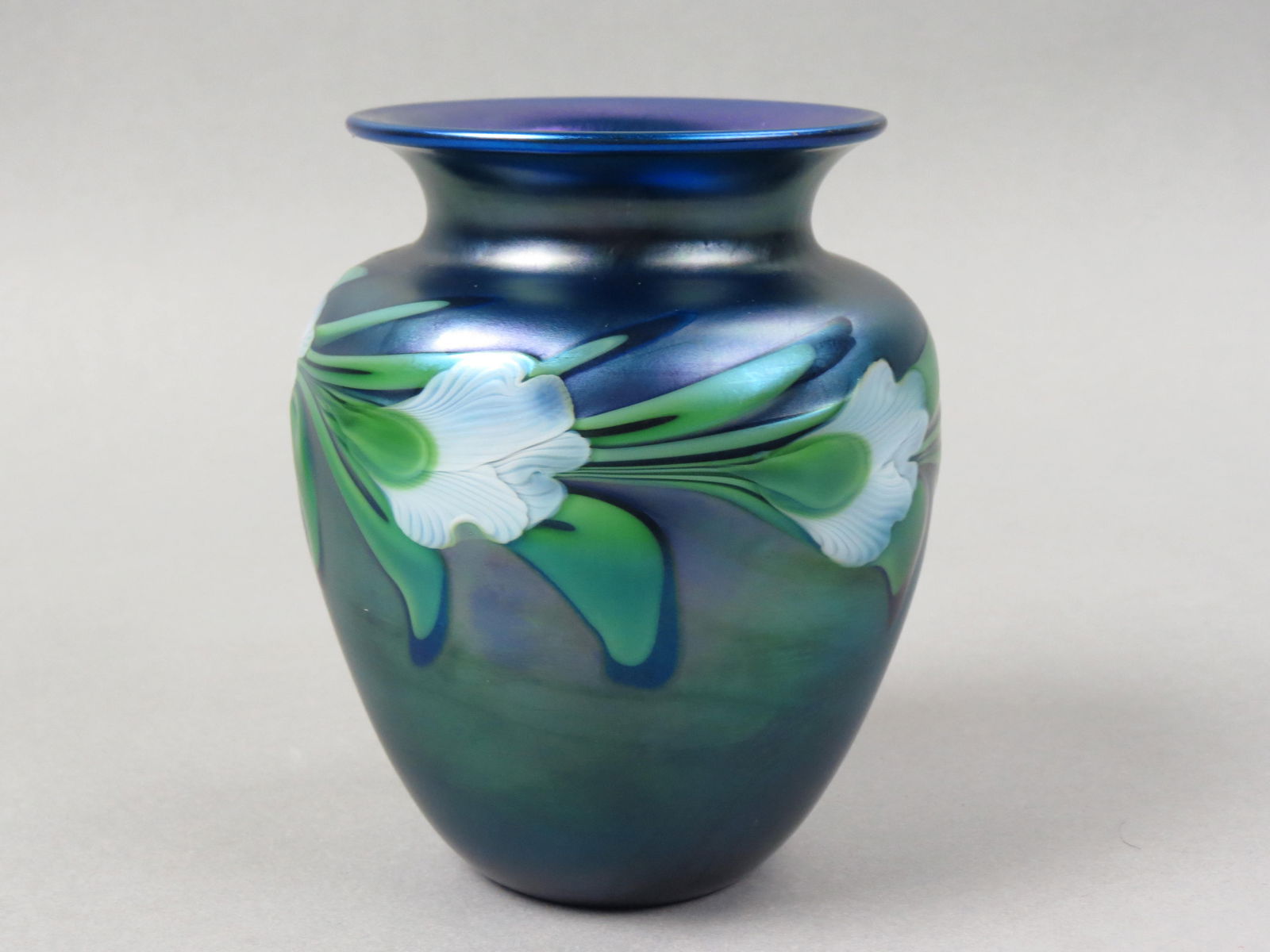 Orient & Flume Studio Art Glass Vase,: flowering vine on rich iridescent blue, artist Shaw, signed and numbered, excellent.