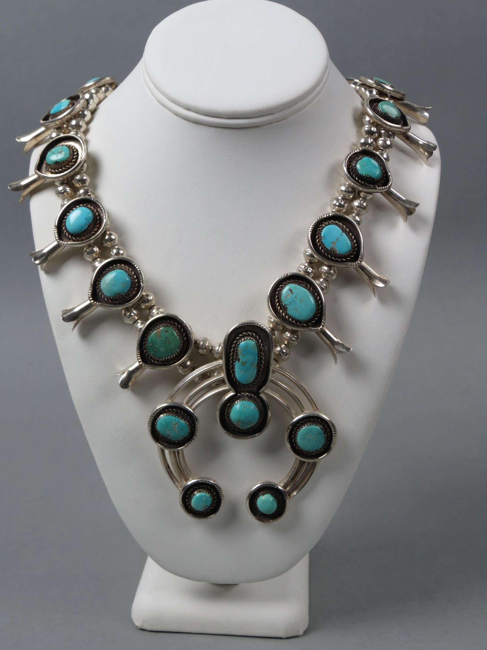 Navajo Turquoise, Sterling Squash Blossom Necklace: with 18 cabochons, 24" long plus 3" Naja, 210 grams.