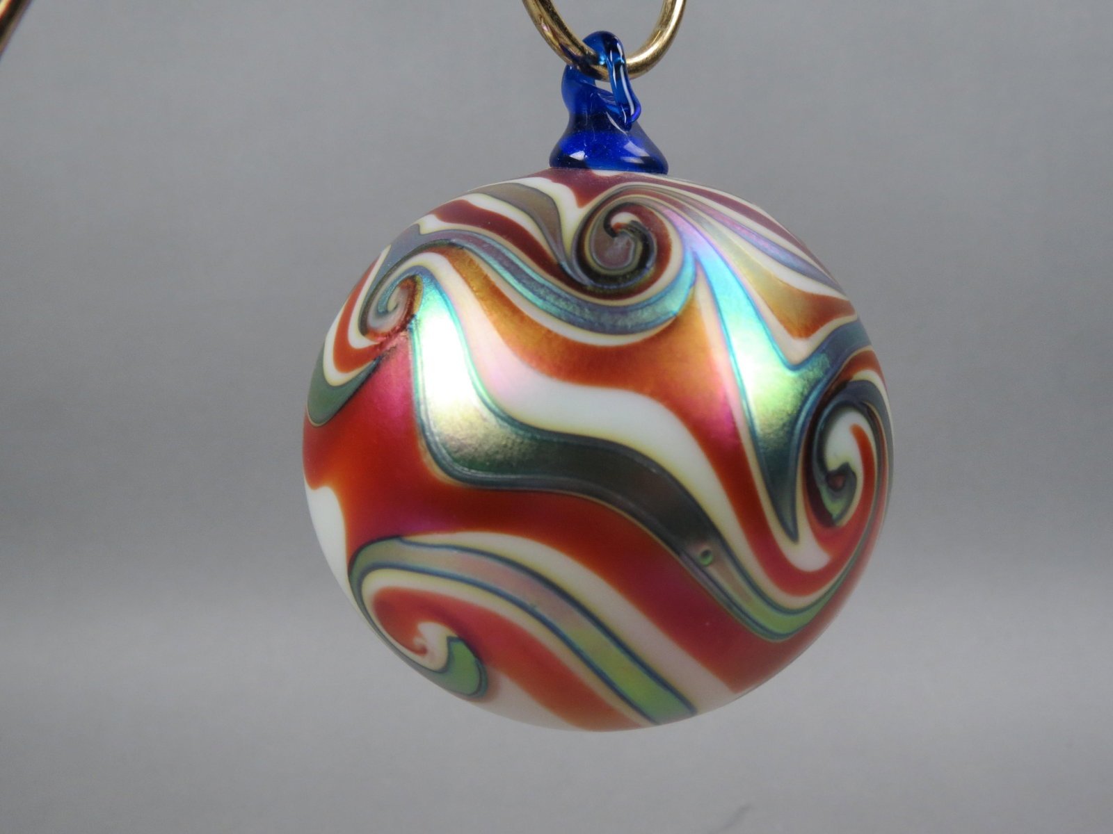 Charles Lotton Studio Art Glass Christmas Ornament: with iridescent silver swirl with golden brown and white swirls, 4" ball form, signed Charles Lotton, 2005, excellent....Charles LottonOctober 21st, 1935 - September 17th, 2021Charles Lotton was born 