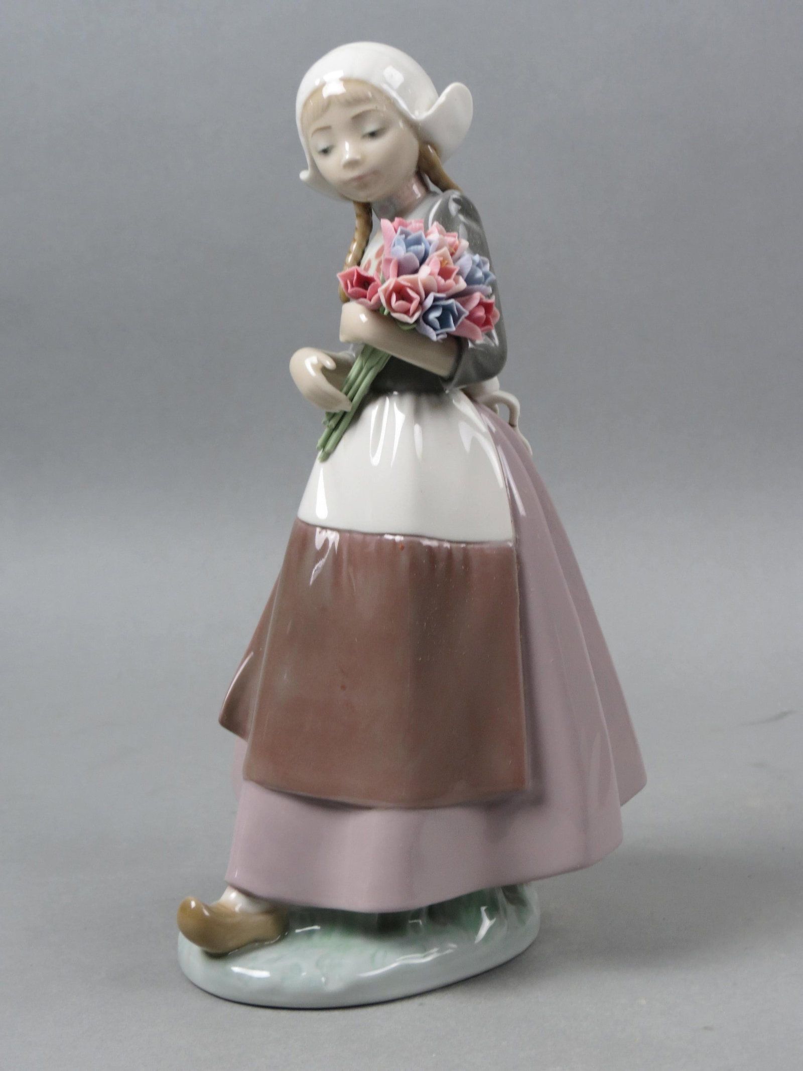Lladro Figurine "Ingrit" #5065,: 10 1/4", issued in 1980 at $370.00, excellent, with box..... Due to fragile nature of the Lladro figurines (fingers and flowers mostly) if you want them shipped by in-house shipping we will no longer 