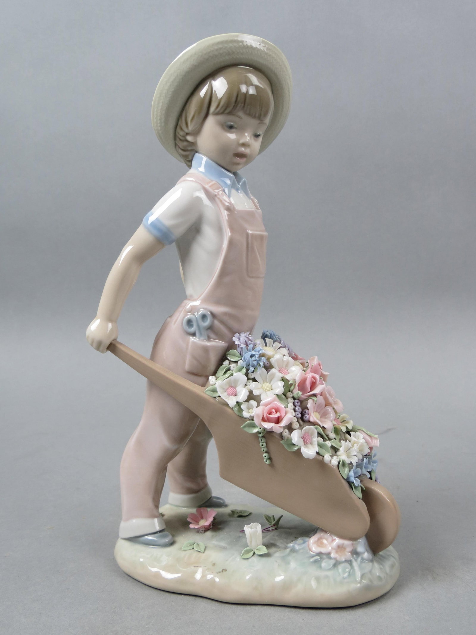 Lladro Figurine "Little Gardener" #1283,: 9", issued in 1974 at $250.00, excellent...... Due to fragile nature of the Lladro figurines (fingers and flowers mostly) if you want them shipped by in-house shipping we will no longer be insuring th