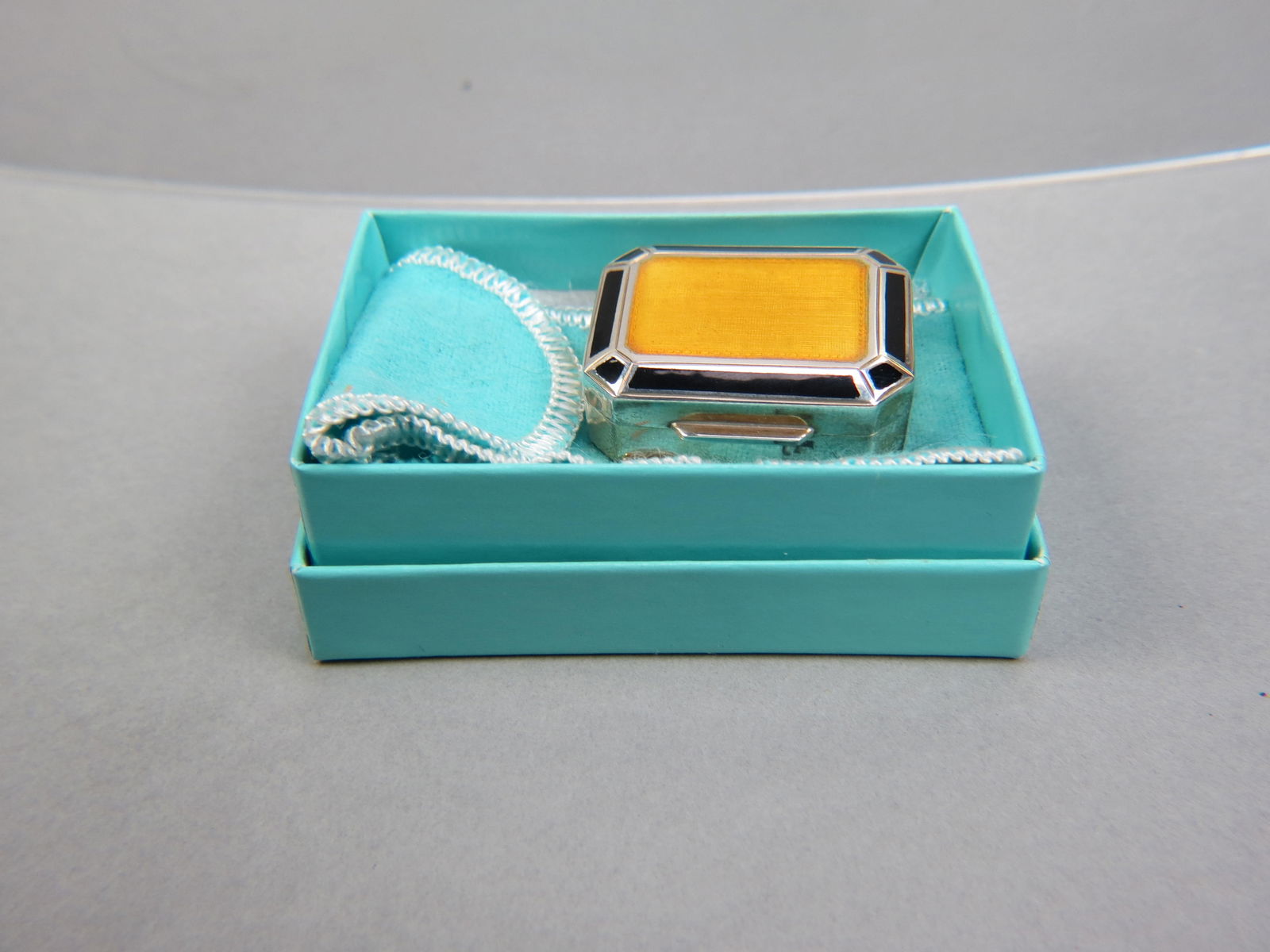 Tiffany Sterling & Enameled Pill Box,: yellow center with black trim, 1 1/4" X 1 1/2", 1/2" deep, 31 grams, signed, excellent.