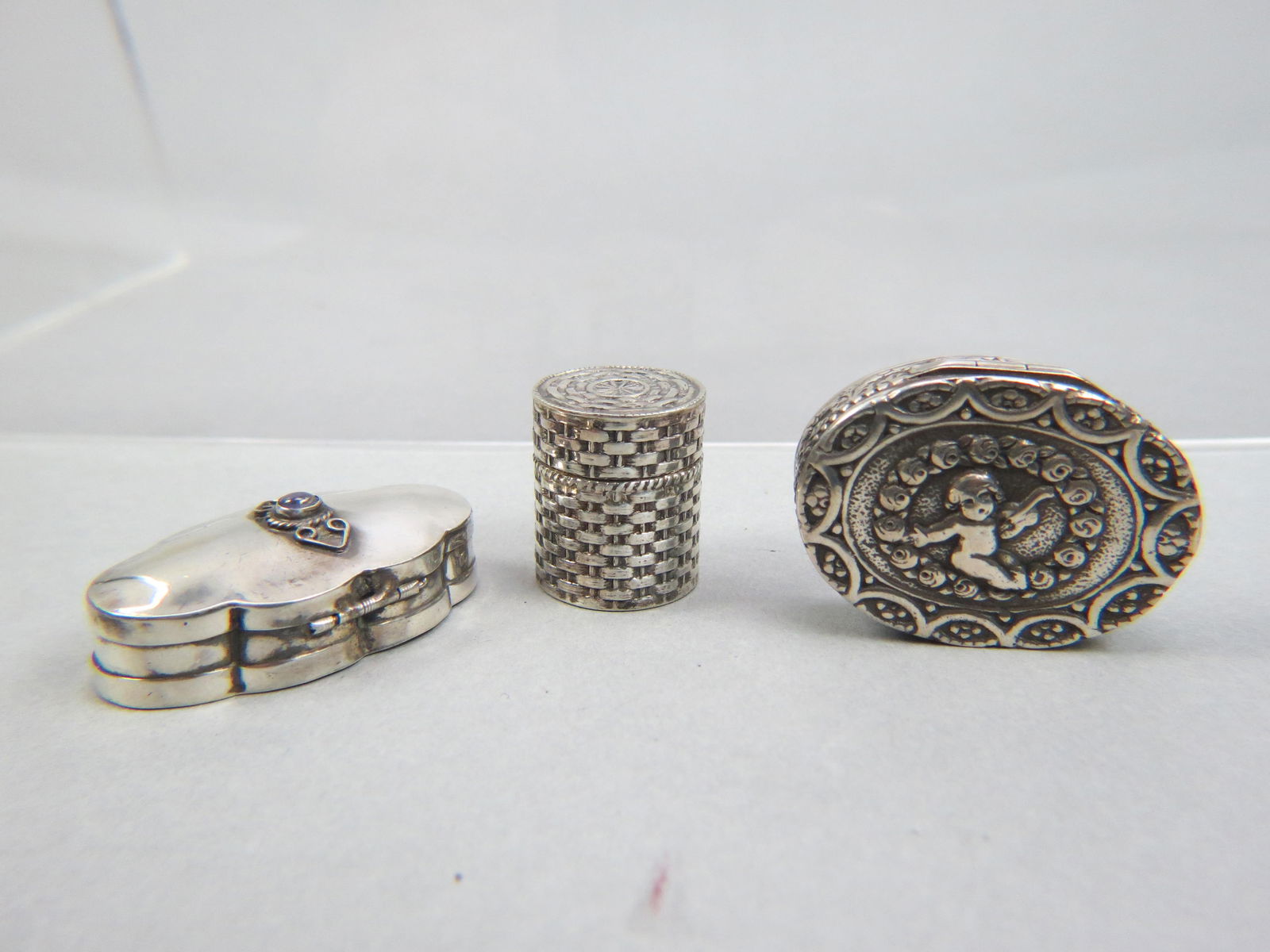 3 Silver Pill Boxes;: Italian .800 silver with child by Coppin, Mexican sterling with amethyst and one sterling with basketweave design, largest is 1" X 1 3/4", 43 grams total.