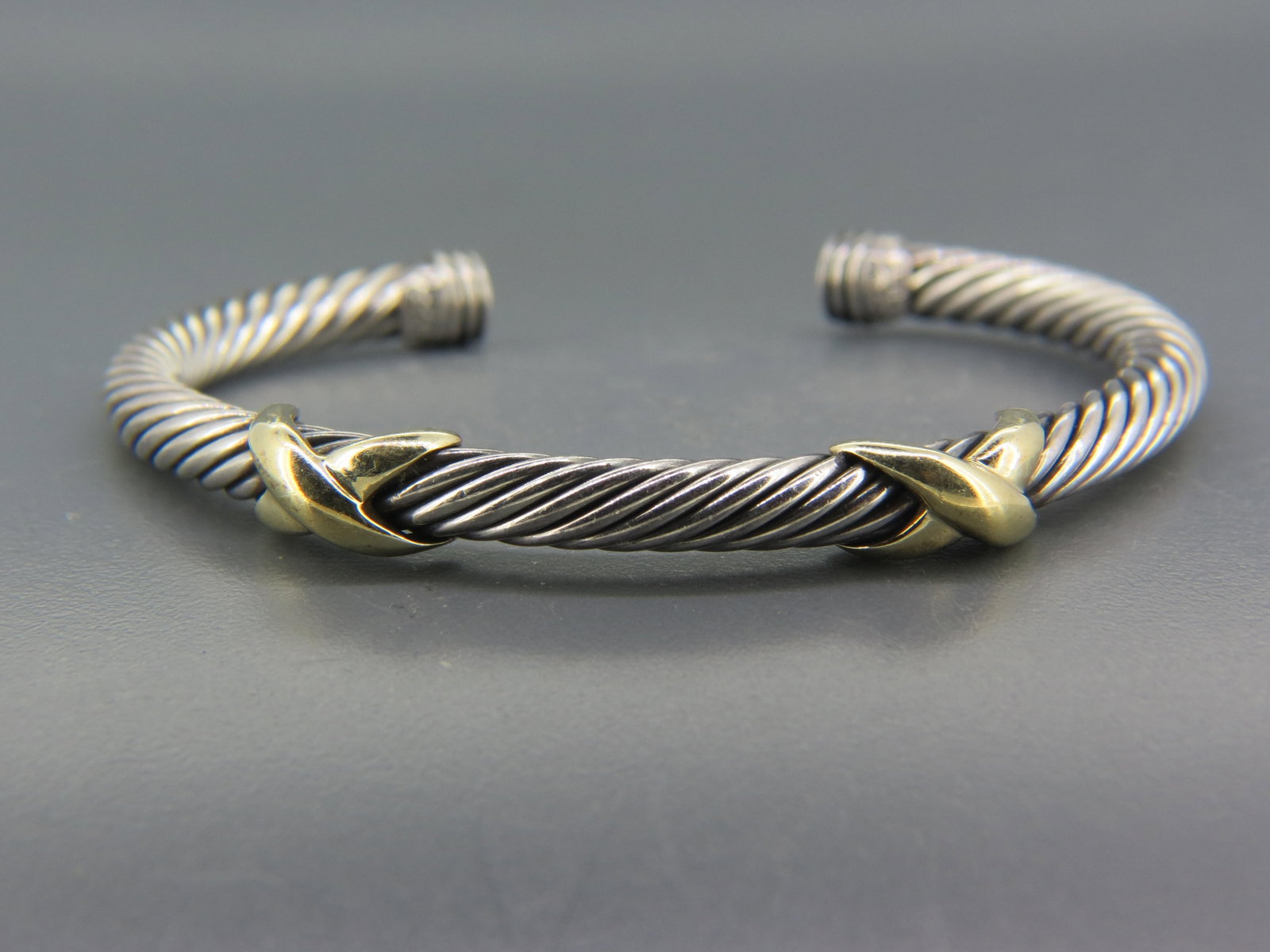 David Yurman 14K Gold & Sterling Silver Bracelet,: 5 mm cable design with "X" decor, 29 grams, signed, 7" wrist size but flexible for a bit larger or smaller size.