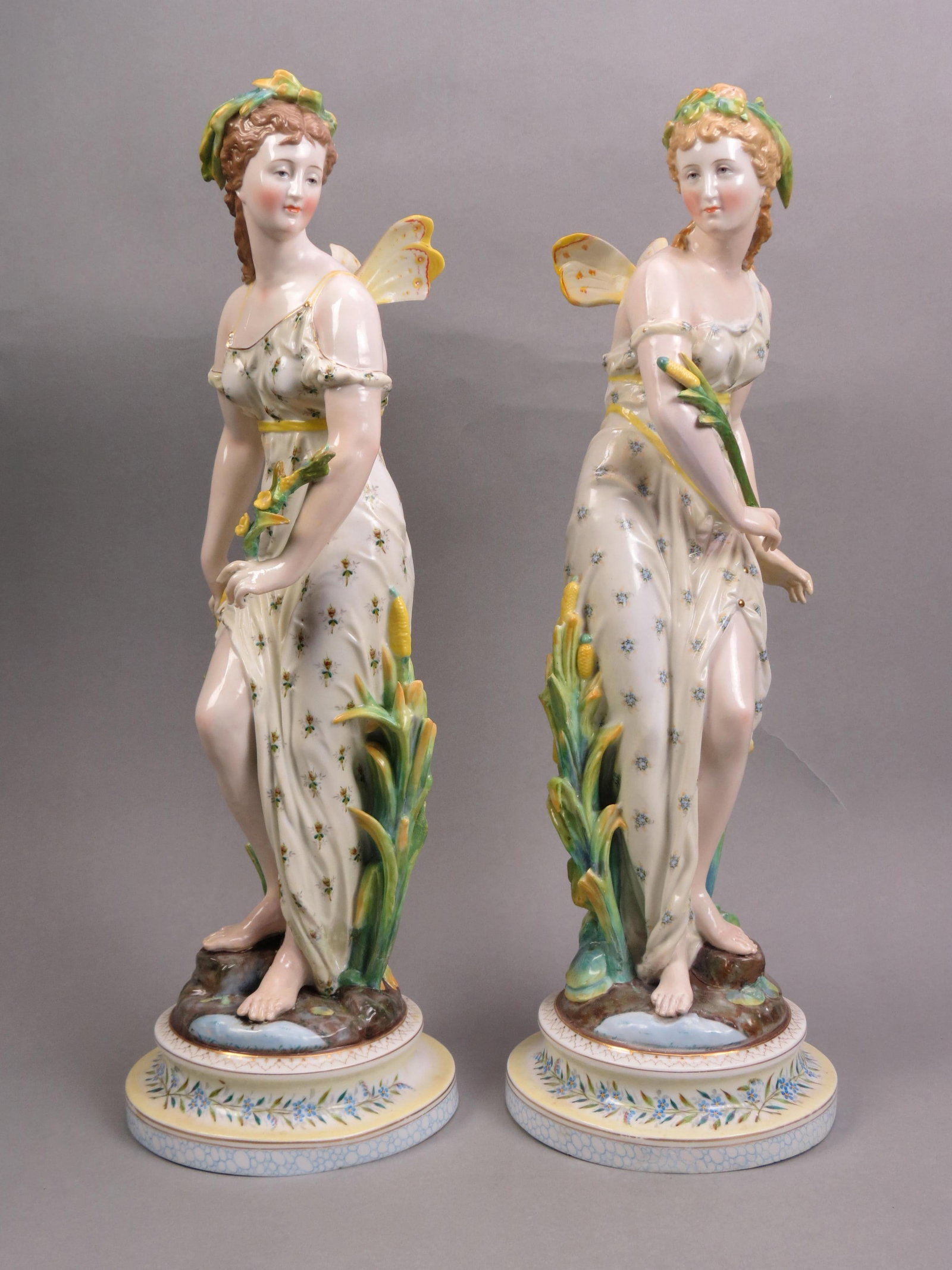 Pair of French Porcelain Female Fairies Figurines,: winged, with flowers, hand painted, 22" tall, 19th century, some restoration, scarce.