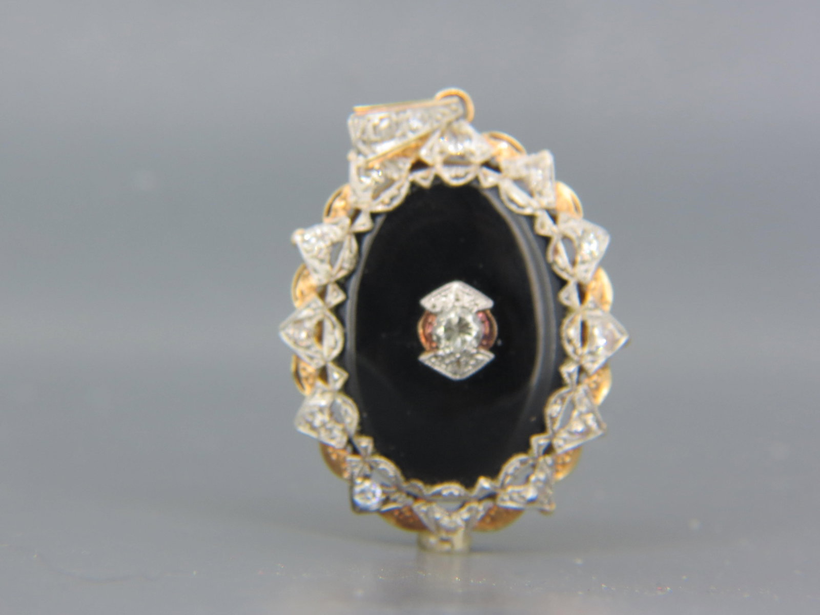 14K Gold Diamond & Black Onyx Locket,: 13 round diamonds totaling 1 carat, black onyx field, 1 1/2" X 1 1/4", 13.7 grams.