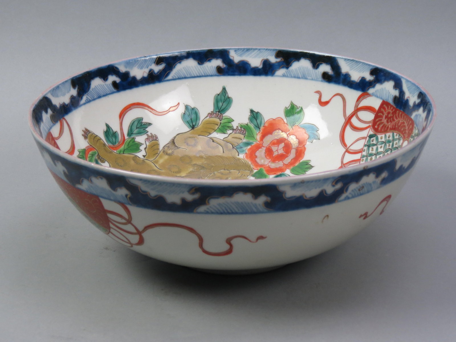 Japanese Imari Porcealin Bowl,: foo dog and floral with dragon in side medallion, 10 3/4" diameter, 4" deep, late 19th century, excellent.