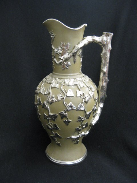 Mettlach Pottery Pitcher,: silver luster leaf & vine decor on brown body, 12 1/4" tall, circa 1890, unmarked, excellent.