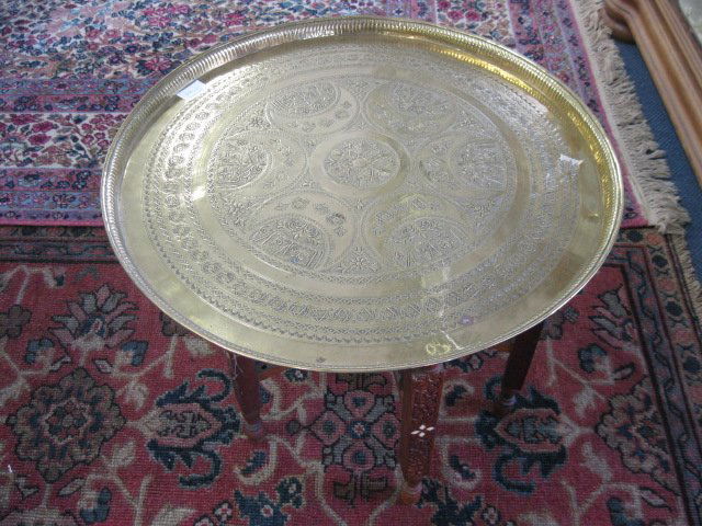 Brass Top Serving or Tea Table,: lift of tray with Islamic designs, 22 1/2" diameter, bone inlaid carved wooden fold-up base.