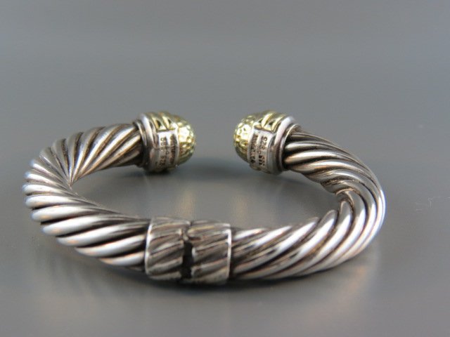 David Yurman 18k Gold & Sterling Bracelet,: large twisted cable decor, gold caps, hinged bangle, signed, 10 mm, 46 grams.David Yurman grew up on Long Island, NY and first stepped out as a designer and businessman selling little sculptures in hi