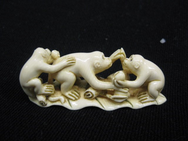 Carved Ivory Netsuke of Three Monkeys,: on a leaf, signed, 1" x 2 1/4".