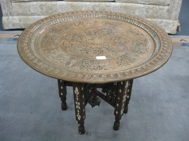 Islamic Coffee Table,: elaborate handhammered & engraved round copper top on folding inlaid wooden base.