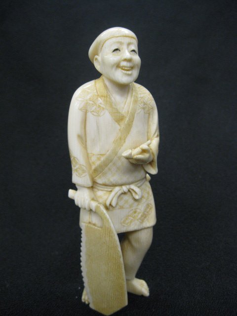 Chinese Carved Ivory Figurine of Man,: holding pipe and large saw, 4 3/4", signed.