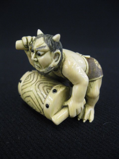 Carved Ivory Netsuke of an Oni,: with a drum, signed, 1 1/2".