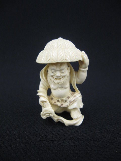 Carved Ivory Netsuke of a Man with Hat,: signed, 1 5/8".