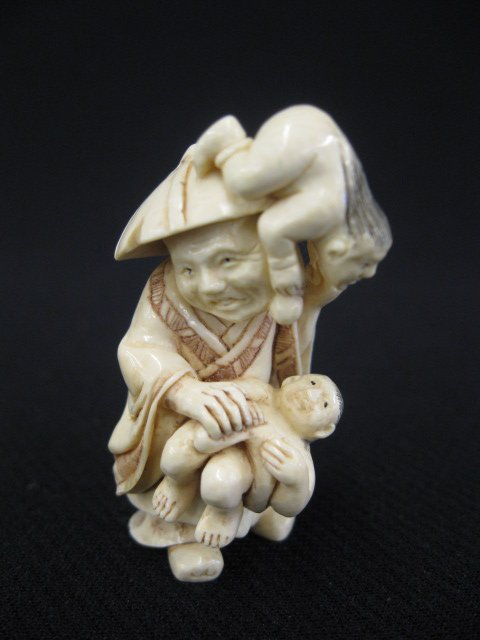 Carved Ivory Netsuke of a Shoki,: a demon qualler, with two oni (demons), signed, 1 7/8".