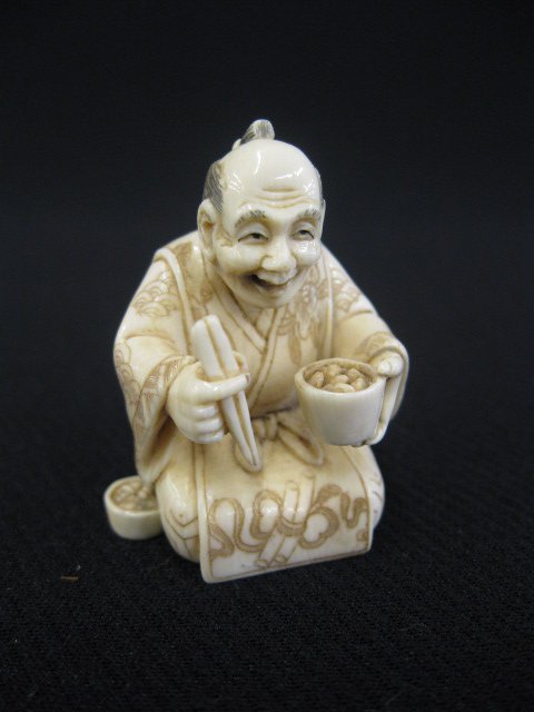 Carved Ivory Netsuke of a Kneeling Man,: holding chopsticks and a rice bowl, signed, 1 1/2".