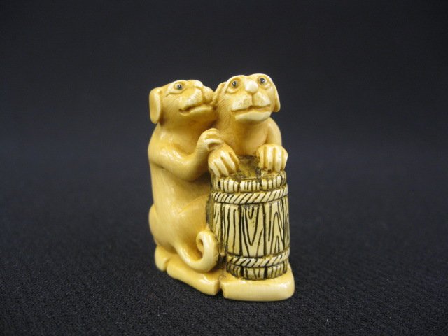 Carved Ivory Netsuke of Two Dogs,: with wooden barrel, 1 1/2", signed.
