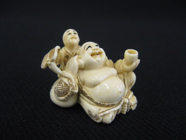 Carved Ivory Netsuke of a Seated buddha,: with attendant, signed, 1 1/8".