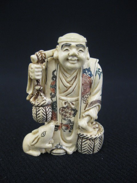 Carved Ivory Netsuke of a Farmer,: holding tools, animal at his feet, fancy polychrome, signed, 1 7/8".