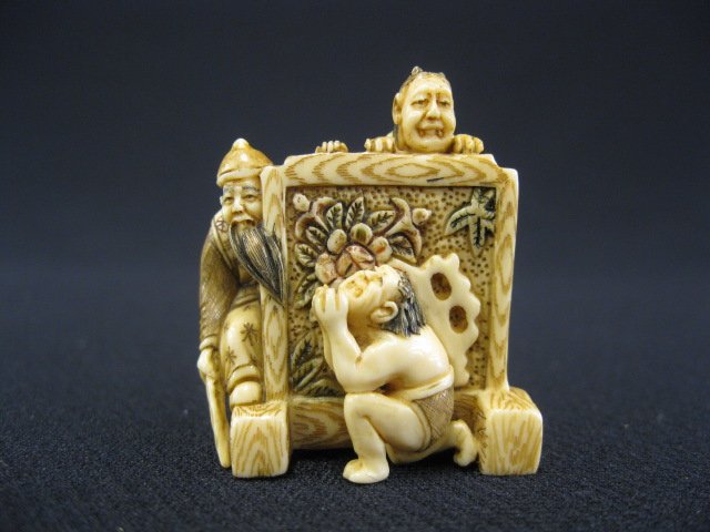 Carved Ivory Netsuke of Shoki,: a demon queller, and an oni behind a screen, another oni in front, signed, 1 1/2".