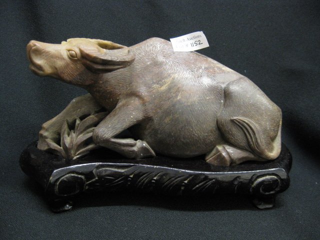 Chinese Carved Soapstone Figurine of an Ox,: at rest, 9" long, on wooden base.