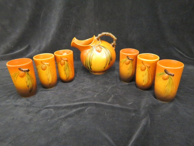 Roseville Pottery "Pinecone" Beverage Set,: brown, ball shape pitcher, #1321, and six tumblers #414, 1931, all excellent.... The Roseville Pottery Company, founded in 1890 in Roseville, Ohio, started producing simple wares like flower pots, umb
