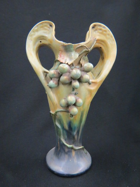 Teplitz Amphora Pottery Vase,: grape & vine decor, handled, gold highlights, 10 1/4", minor loss..Between 1892 and 1918 the Amphora Pottery Company manufactured thousands of remarkably imaginative and delicately crafted ceramic ves