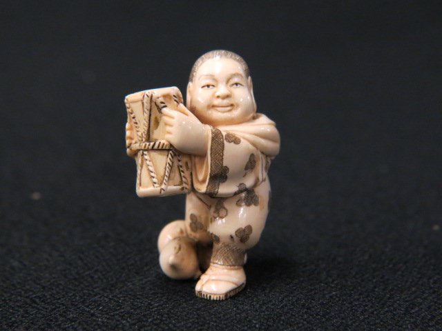 Carved Ivory Netsuke of a Boy,: holding a drum, gourd at his feet, 1 3/4" tall, signed, excellent.