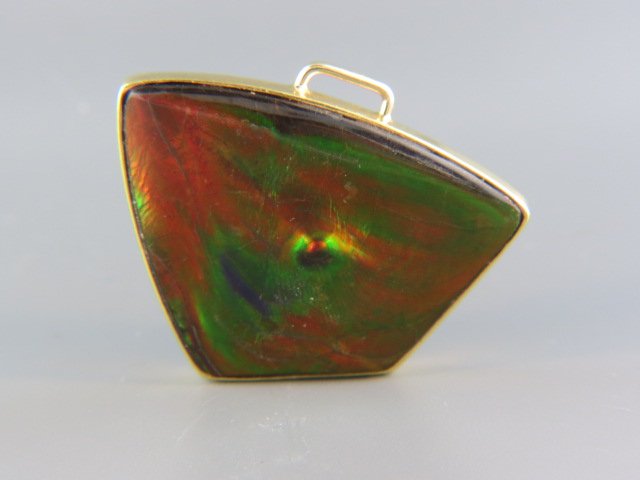 Opal Pendant,: fiery semi-crystal brown opal, freeform cabochon, 40 x 30 mm, 32 carats, 18k yellow gold frame, with appraisal of $8,750.00