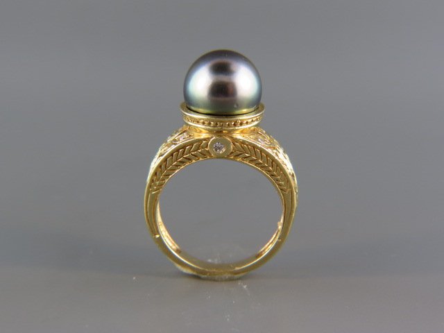 Black Tahitian South Sea Pearl Ring,: 11 mm pearl with 10 diamonds totaling .20 carat in carved style 18k yellow gold setting, 11.4 grams, with appraisal of $2,550.00, currently size 8.