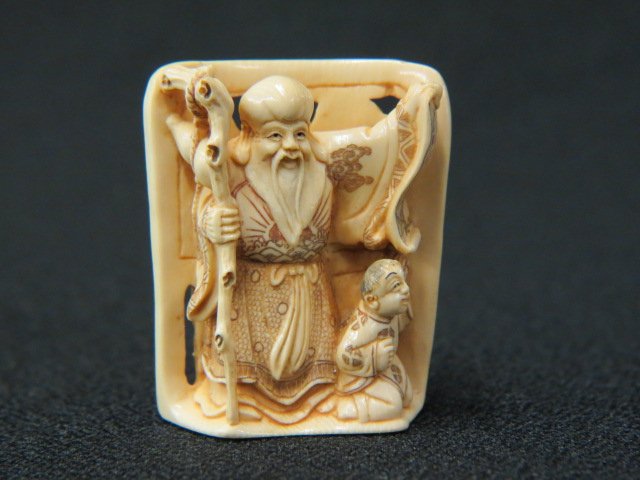 Carved Ivory Netsuke of Fukurokuju,: (god of wisdom & longevity), holding a scroll, child a side, 1 3/4", signed, excellent.
