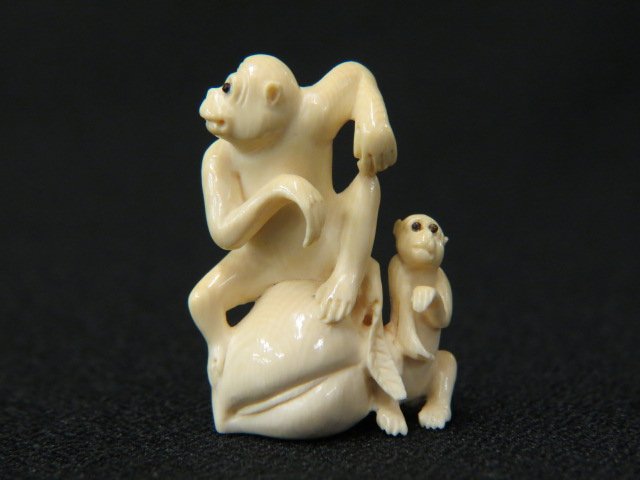 Carved Ivory Netsuke of Two Monkeys,: with a large peach, 1 1/2", onyx inlaid eyes, signed, excellent.
