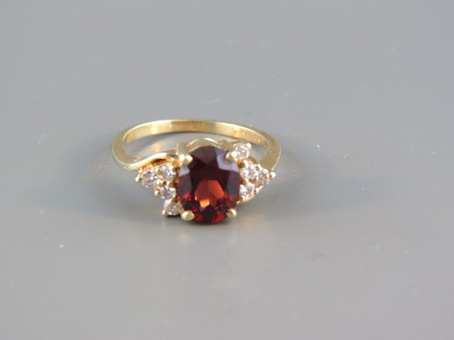 Garnet & Diamond Ring,: rich oval rhodalite gem with 4 diamonds on each side, .30 carat total, 14k yellow gold, currently size 6 1/2.