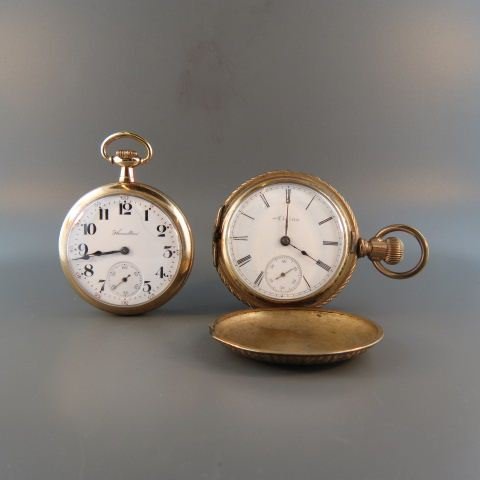 2 Pocketwatches;: Hamilton openface 17 jewel, gold-filled case, working together with an Elgin hunting case, gold-filled, with one cover off and not working.