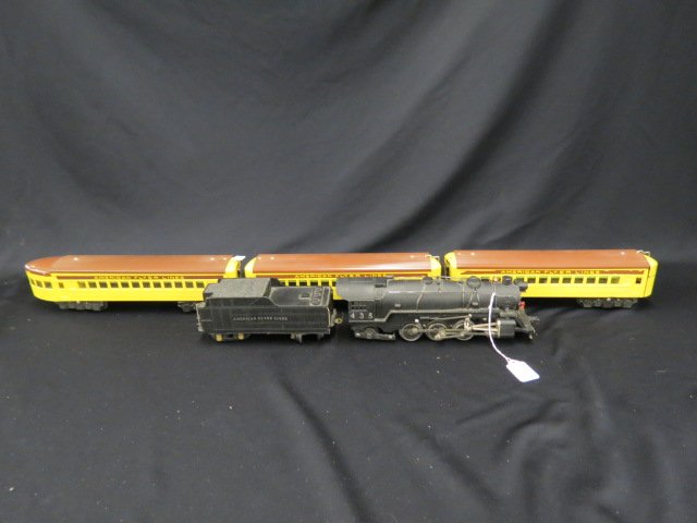 American Flyer Tin Passenger Train Set,: engine #435 with trailer and 3 yellow passenger cars, still with boxes, excellent, except for some reason the engines tender car has loss to the metal in front bottom and back bottom area.