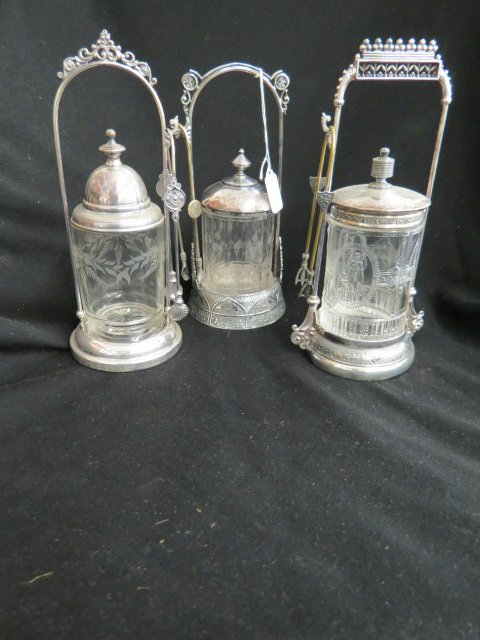 3 Victorian Silverplate Pickle Castors,: venus & cupid and etched designs, with tongs, 10 1/2."