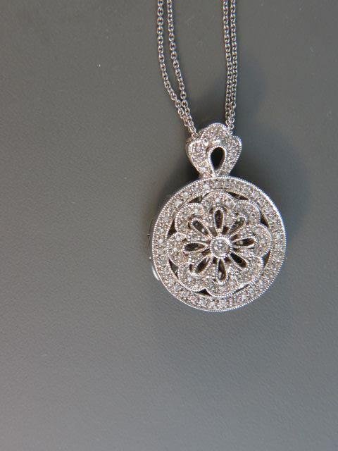 Diamond Locket,: 78 round diamonds totaling .50 carat in fancy 14k white gold, on two strand chain, with appraisal of $2550.