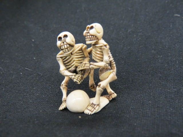 Carved Ivory Netsuke of Two Skeletons: playing soccer, signed, 1 3/4", excellent.