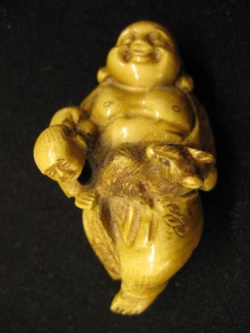 Carved Ivory Netsuke of Hotei,: god of happiness, cat on his stomach, child at his side, 2 1/2" long, signed, excellent.