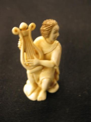 Carved Ivory Netsuke of a Seated Lady: playing a lyre, 2", signed, excellent.