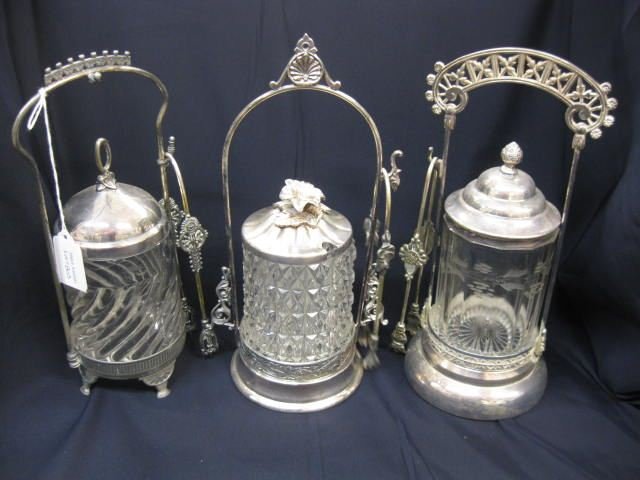 3 Victorian Silverplate Pickle Castors,: fancy clear glass inserts, with tongs, circa 1890, 10" tall.