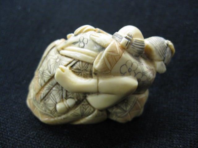 Carved Ivory Erotic Netsuke of a Couple,: fancy polychrome work, 1 5/8" x 2", signed, excellent.