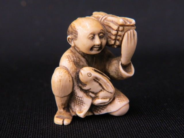Carved Ivory Netsuke of Man: with load of firewood & a rabbit, 1 5/8", signed, excellent.