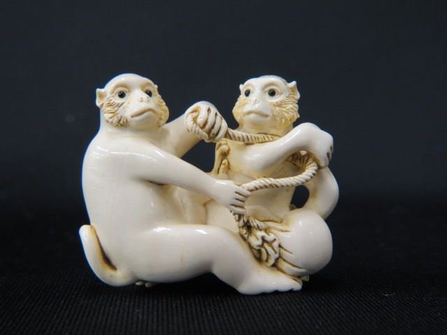 Carved Ivory Netsuke of Two Monkeys,: with a peach, onyx eyes, 1 3/4", signed, excellent.
