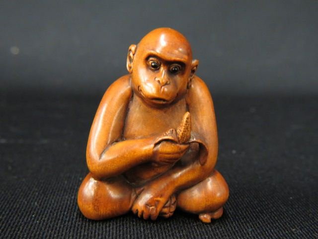Carved Wood Netsuke of a Monkey,: eating a banana, onyx eyes, 2", signed, excellent.