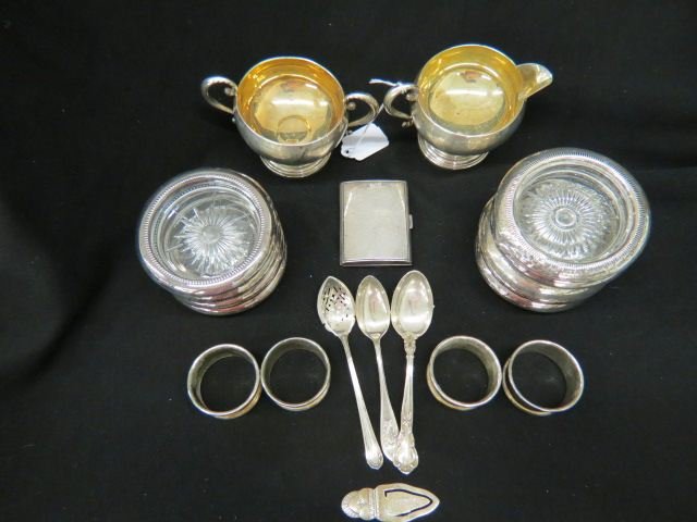 Estate Sterling Lot;: cigarette case, creamer & sugar (weighted), olive spoon, bookmark, 2 teaspoons, 9 rimmed coasters, together with 4 plated napkin rings.
